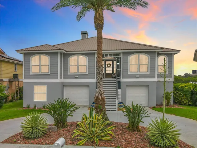 Bathed in the warm glow of twilight, the front of this beautiful home invites you to envision a new chapter of life by the water. Let the enchanting ambiance and inviting essence of waterfront living capture your heart and inspire endless memories.