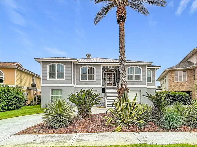 Discover exceptional curb appeal in this stunning waterfront home, designed for coastal living with professionally landscaped gardens and ample parking for all your guests.