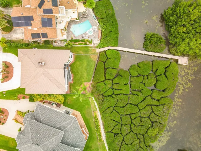 This stunning drone shot highlights the exquisite placement of the home against the backdrop of shimmering waters and flourishing mangroves, illustrating the peaceful essence of waterfront living.