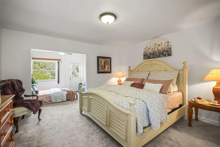 Large primary bedroom with tall ceilings