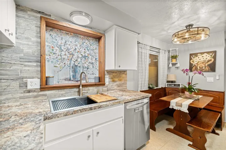 Kitchen sink has been updated and paired with a modern touchless faucet.