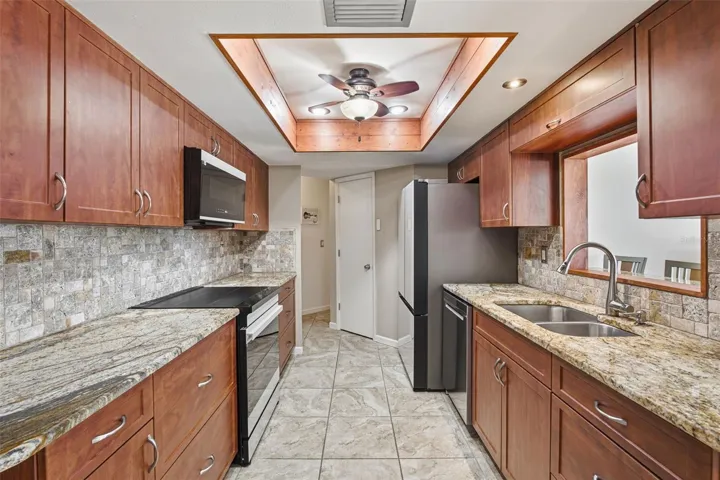 Updated Kitchen with Granite Countertops and Rich Wood Cabinetry.