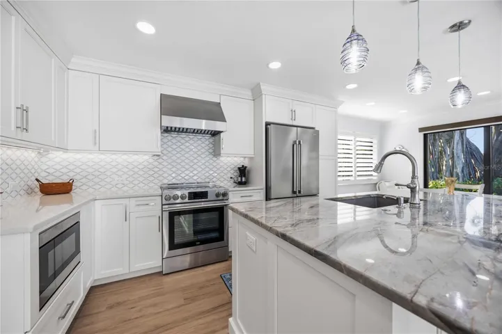 Modern kitchen showcases custom tile backsplash, premium finishes, and stylish coastal design details.