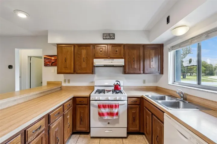Lots of built in storage to this kitchen with gas appliances.