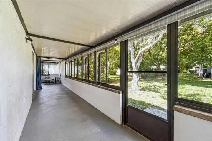 Huge back porch with the office space at the end.  Lovely shaded backyard area.
