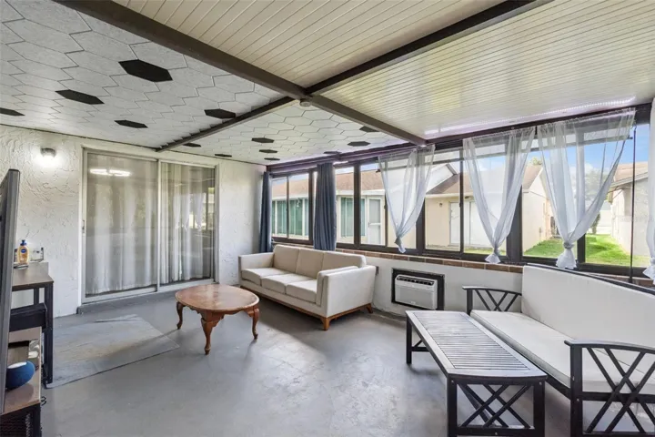 Back Patio space being used as an office beyond the master sliding doors.