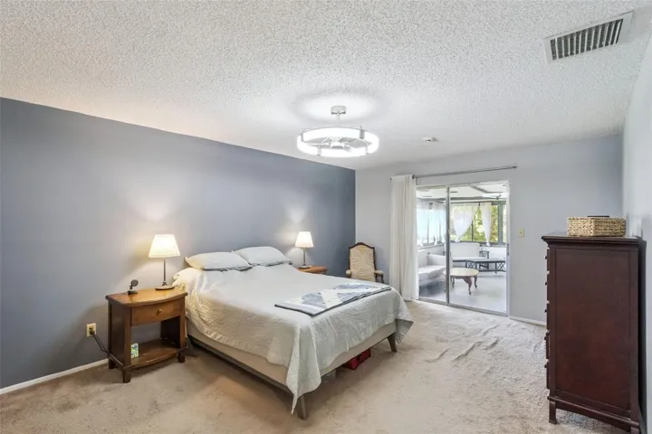 The primary suite is HUGE with sliders to the extended wrap-around porch that has its own A/C.