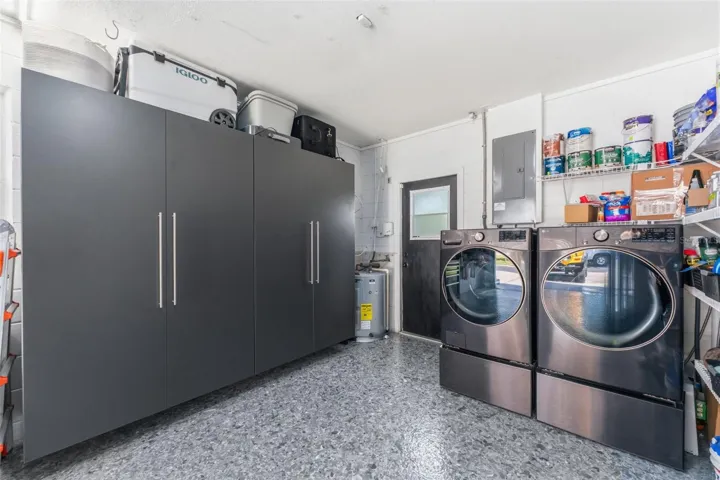 Garage with epoxied floors, storage and your laundry