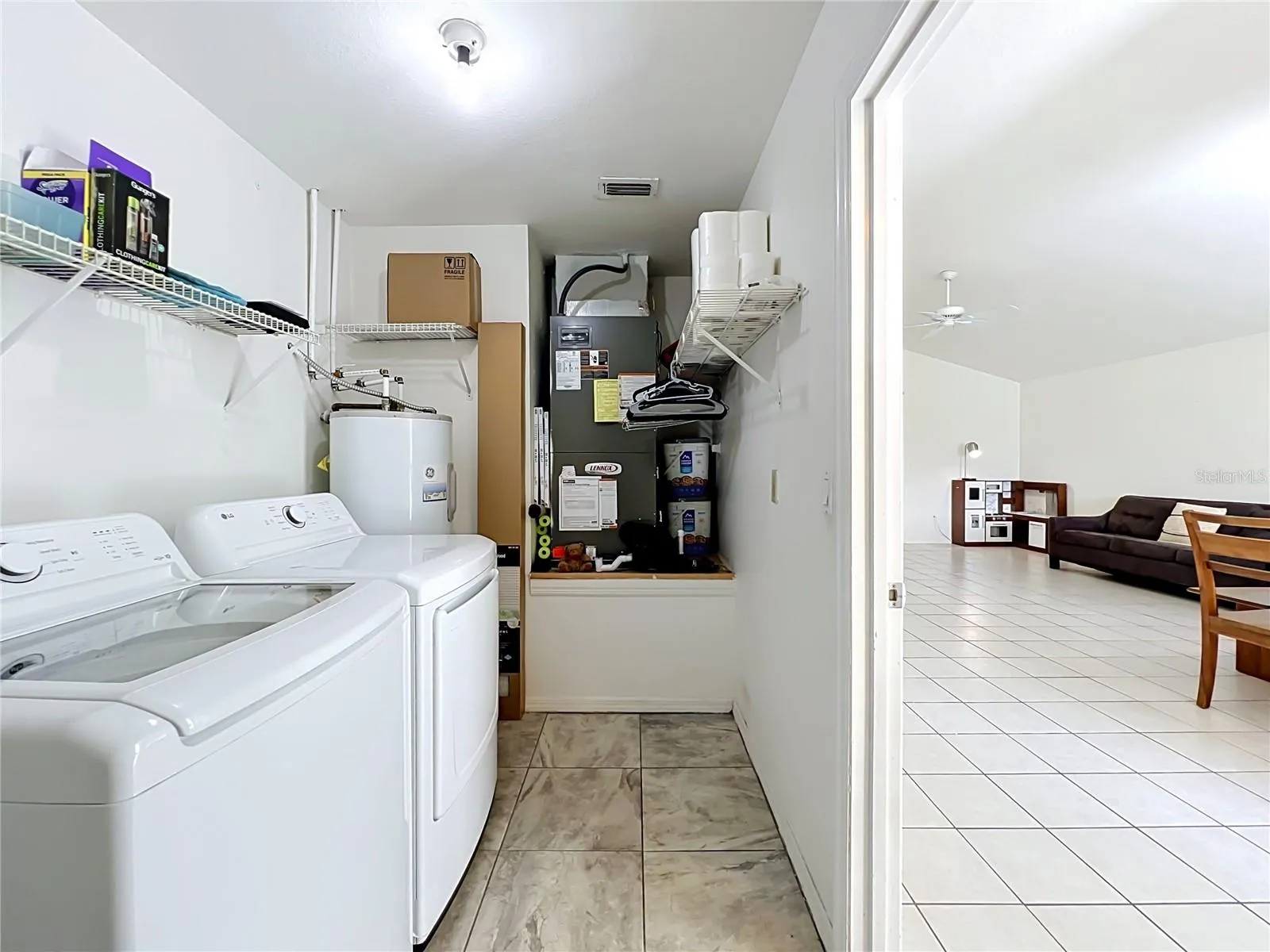 Enter this home through the garage, which leads directly into a convenient laundry and utility room.