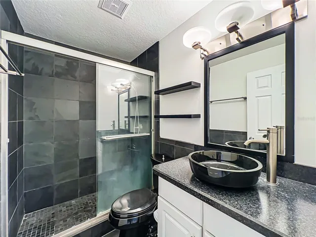 Updated bathroom featuring a walk-in shower; no bathtub present.