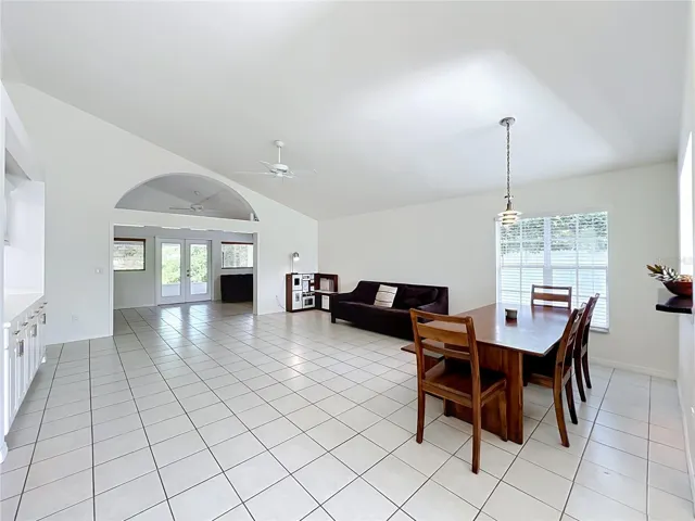 Spacious great room featuring soaring ceilings, custom built-ins, and a seamless transition into the light-filled Florida room.