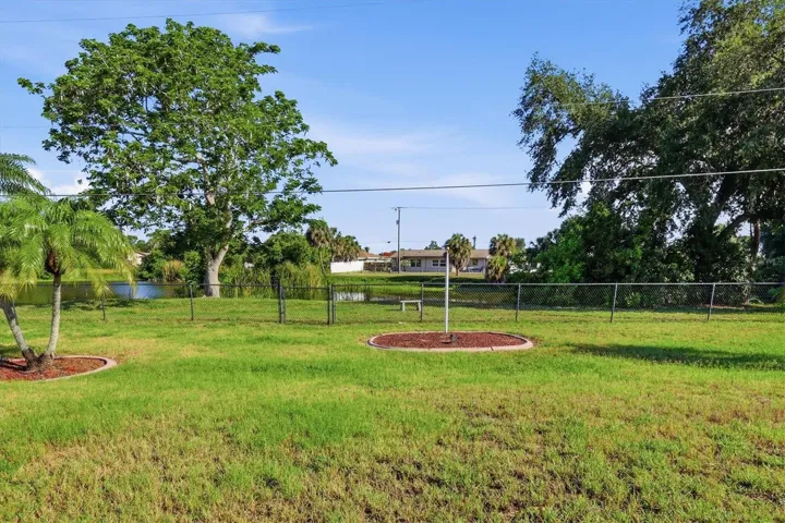 Fenced back yard with pond view.