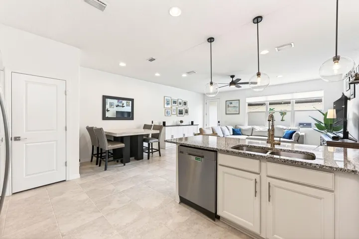 The modern kitchen is open to the living and dining areas.