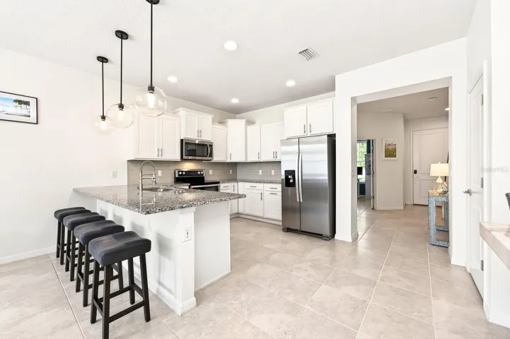 High ceilings and tile flooring throughout the main living areas create a bright, open feel, while the stylish kitchen is sure to impress.