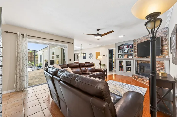 Family room is open to the kitchen with sliding glass door access to the screened lanai.