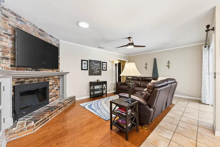 Family room is complete with a brick fireplace.
