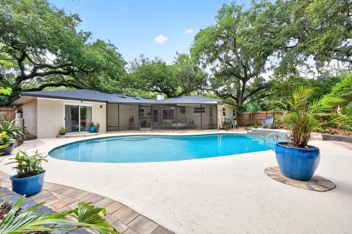 Enjoy your personal backyard oasis - gorgeous mature trees create a park-like setting for you to enjoy a screened lanai, private pool and fully fenced yard.