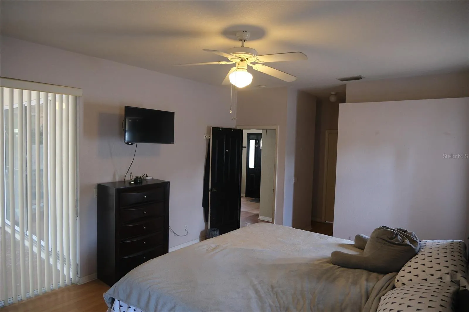 View of sliding door in primary bedroom leading to patio