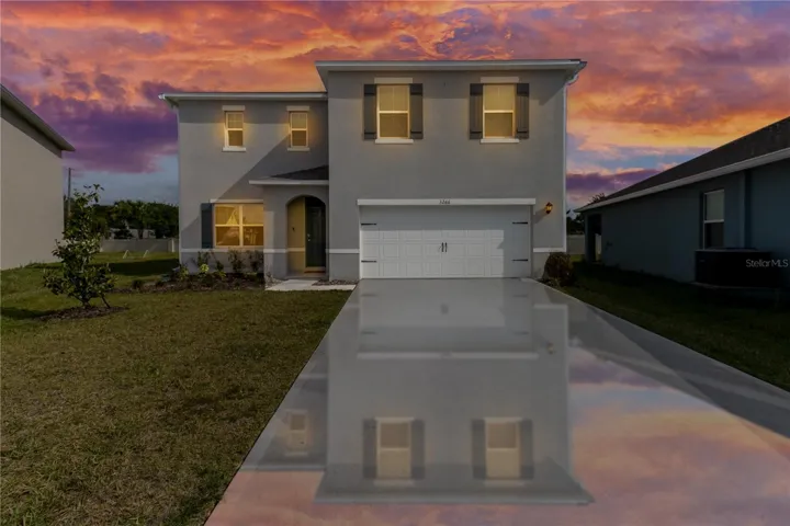 Modern front elevation featuring extended driveway, 2-car garage, and excellent curb appeal.