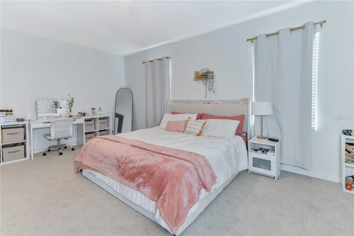 Spacious primary suite with neutral finishes and abundant natural light.