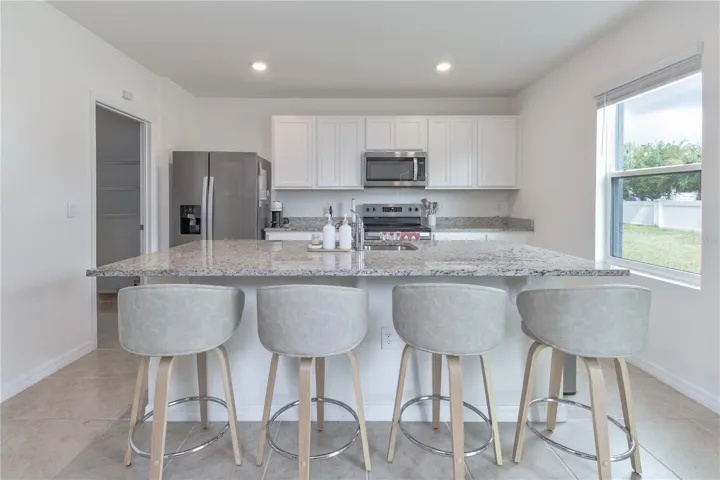 Beautiful kitchen featuring granite countertops, stainless steel appliances, and large island.