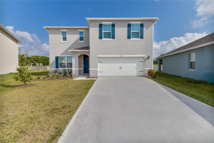 Beautiful exterior front view showcasing the spacious lot and updated exterior finishes.