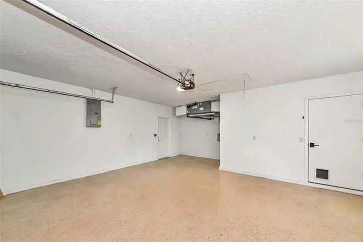 Garage with extra storage area and painted floor