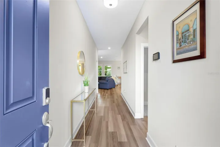 Light and Bright Hallway with Luxury Vinyl Flooring leading to 2 Guest Bedrooms and the Open Floor-plan Kitchen/Great Room