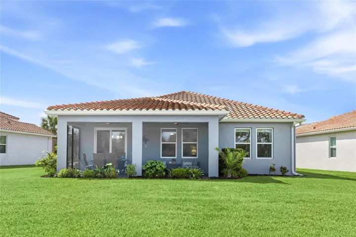 Rear view of screened in, covered and extended Lanai with access door, two ceiling fans and panoramic water and preserve views. Plenty of room for a pool or extended cage with pavers.