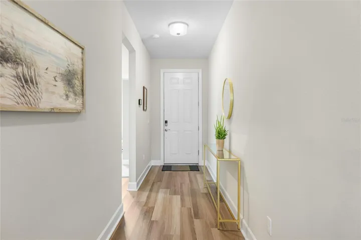 Light and Bright Hallway with Luxury Vinyl Flooring leading to 2 Guest Bedrooms and the Open Floor-plan Kitchen/Great Room