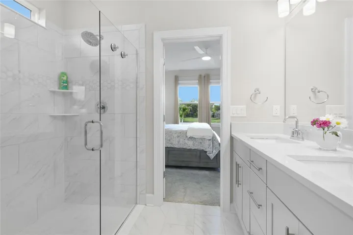 Owners ensuite bathroom with quartz countertops with dual sinks. large full glass shower