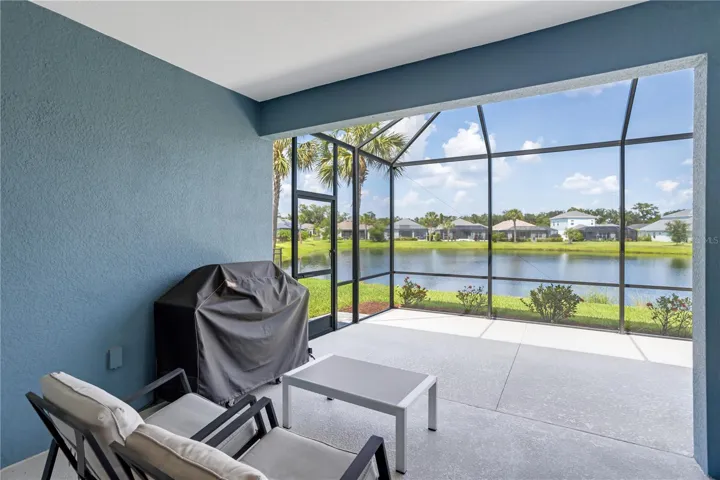 Massive covered outdoor living area offers year-round Florida enjoyment with tranquil water views.