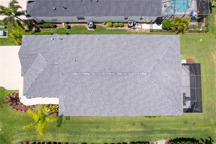 Direct Overhead Property ViewThis bird’s-eye view showcases the home’s lot placement, screened outdoor living space, and beautifully maintained landscaping from above.