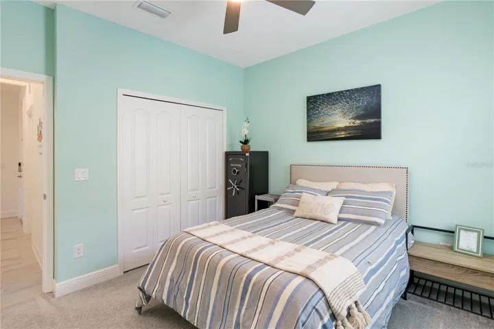 Spacious Secondary Bedroom with Designer TouchesGenerously sized and beautifully maintained, this secondary bedroom offers high ceilings, plush carpeting, and a soothing coastal color palette. Plantation shutters provide privacy and energy efficiency while enhancing the home’s upscale feel buyers are searching for in Southwest Florida homes.