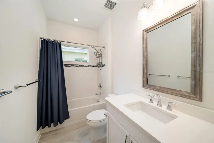 Beautifully Appointed Guest BathroomThe guest bathroom features quartz countertops, upgraded cabinetry, designer lighting, and clean modern finishes. Bright and inviting, it provides comfort and convenience for visiting guests while maintaining the elegant feel carried throughout the home.