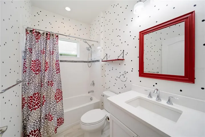 Designer Accent Guest BathThis charming secondary bath adds personality and style with custom accent wall detailing and designer touches. The spacious vanity, upgraded fixtures, and natural light create a welcoming space that stands out from typical builder-grade homes.