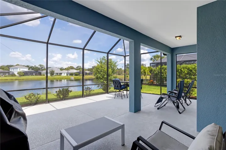 Oversized screened lanai provides multiple seating and dining areas for family gatherings.
