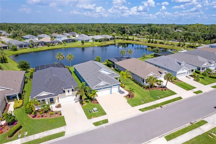 Aerial View of Community and Lake SettingDrone photography highlights the home’s beautiful positioning within the community, showcasing nearby lake views, mature landscaping, and the spacious layout of this desirable Florida neighborhood. Buyers searching for peaceful surroundings and resort-style living will immediately appreciate the setting.