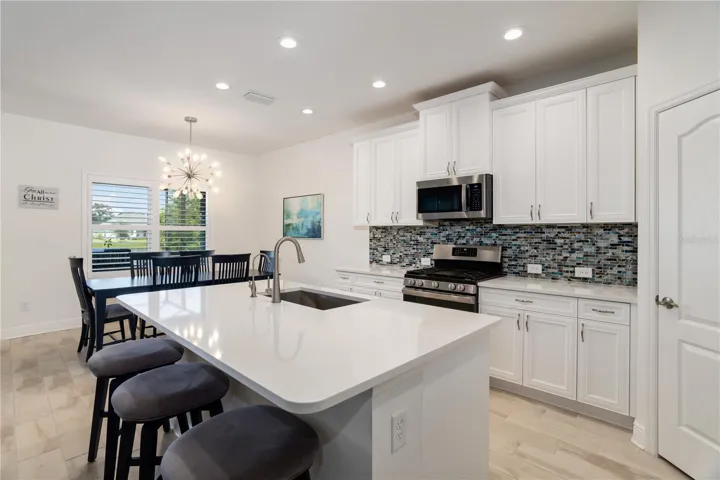 Custom Kitchen with Gas Range, Designer Backsplash & Ample StorageBeautifully upgraded kitchen featuring gas cooking, tall cabinetry, modern hardware, and stylish backsplash accents. Buyers looking for newer luxury homes with gourmet kitchens and high-end details will love this space.