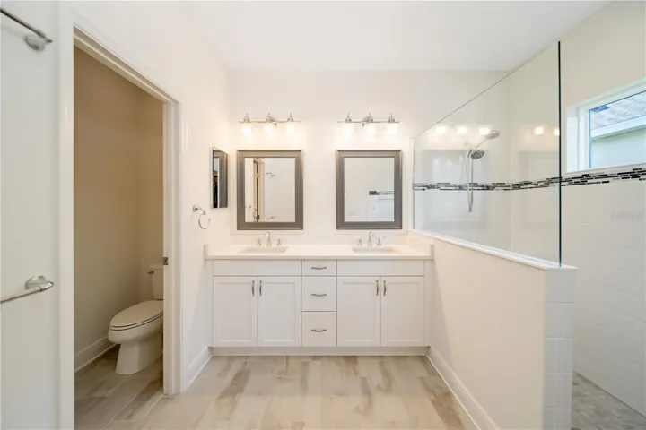 Luxury Owner’s Bathroom RetreatThe spacious owner’s bath delivers spa-like comfort with dual vanities, quartz countertops, upgraded cabinetry, and an oversized walk-in shower. Designed for both relaxation and functionality, this elegant primary suite bath creates a true private retreat experience.