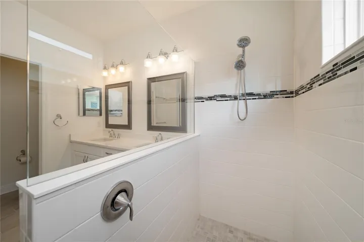 Oversized Walk-In ShowerThe large walk-in shower features upgraded tile work, dual shower heads, glass enclosure detailing, and a clean modern design that adds a luxurious touch to the primary suite. This spa-inspired feature is highly desirable for buyers seeking newer construction homes in Florida.