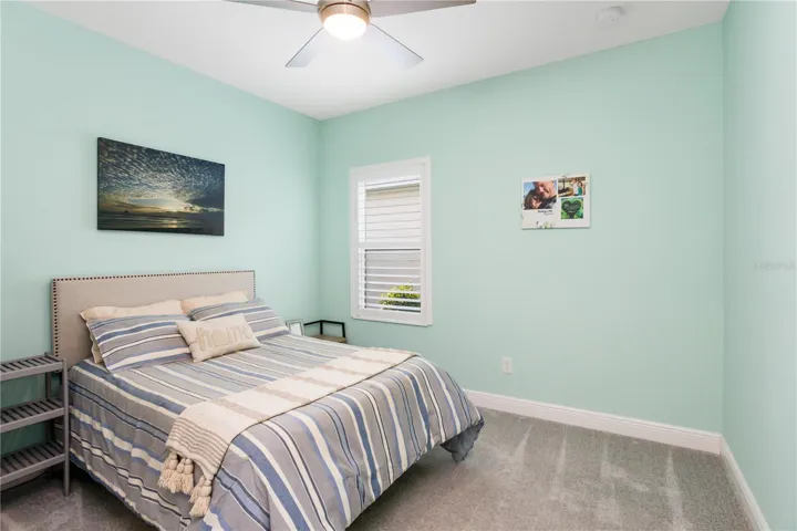 Bright Coastal-Inspired BedroomThis beautifully designed guest bedroom features soft coastal tones, abundant natural light, and a relaxing atmosphere that perfectly complements the Florida lifestyle. Ideal for family visits or multigenerational living, the room offers comfort, privacy, and easy access to the home’s secondary bath.