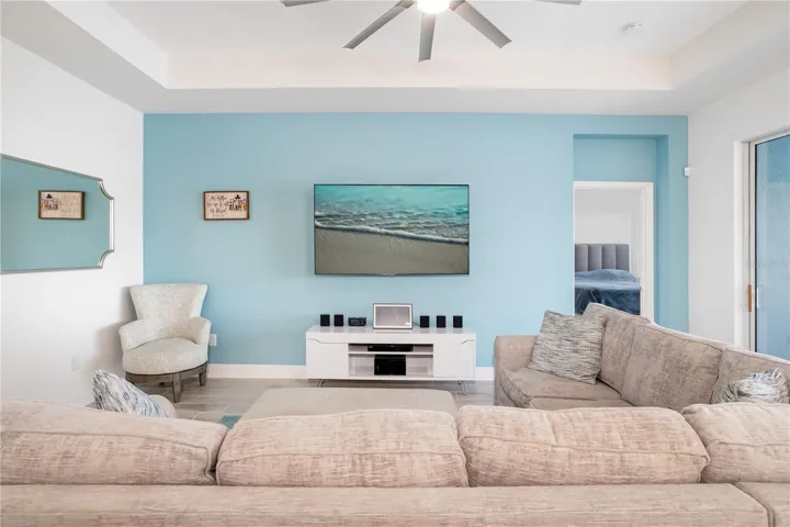 Modern Coastal Family Room with Lakefront Views & Natural LightBeautiful gathering space designed for comfort and connection, featuring large windows, neutral finishes, and calming coastal colors inspired by Florida waterfront living. Excellent for buyers wanting a move-in-ready luxury home near Sarasota and Lakewood Ranch.