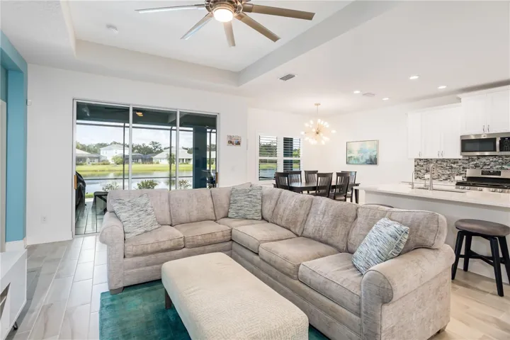 Designer Living Area Flowing Seamlessly into Kitchen & Dining SpaceOpen-concept floorplan connecting the great room, kitchen, and dining area with natural light throughout. Buyers searching for newer construction homes with entertaining space, water views, and a bright airy feel will appreciate this highly desirable layout.