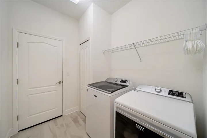 Functional Laundry Room with Storage PotentialThe spacious interior laundry room offers modern appliances, extra storage opportunities, and easy access within the home. Bright finishes and practical layout make everyday tasks simple while maintaining the home’s clean, upscale presentation.