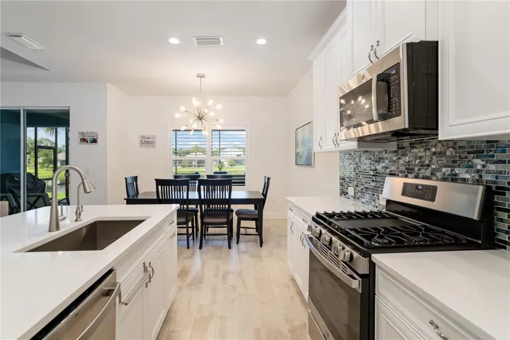 Modern Gourmet Kitchen with Coastal Finishes & Stainless AppliancesBright and sophisticated kitchen featuring stainless steel appliances, quartz surfaces, custom cabinetry, and designer finishes throughout. Excellent for buyers relocating to Florida wanting a turnkey luxury residence.