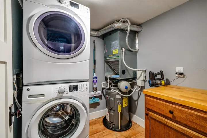 Laundry with stackable units, water heater (2024), HVAC (6/26), storage cabinet with top for folding