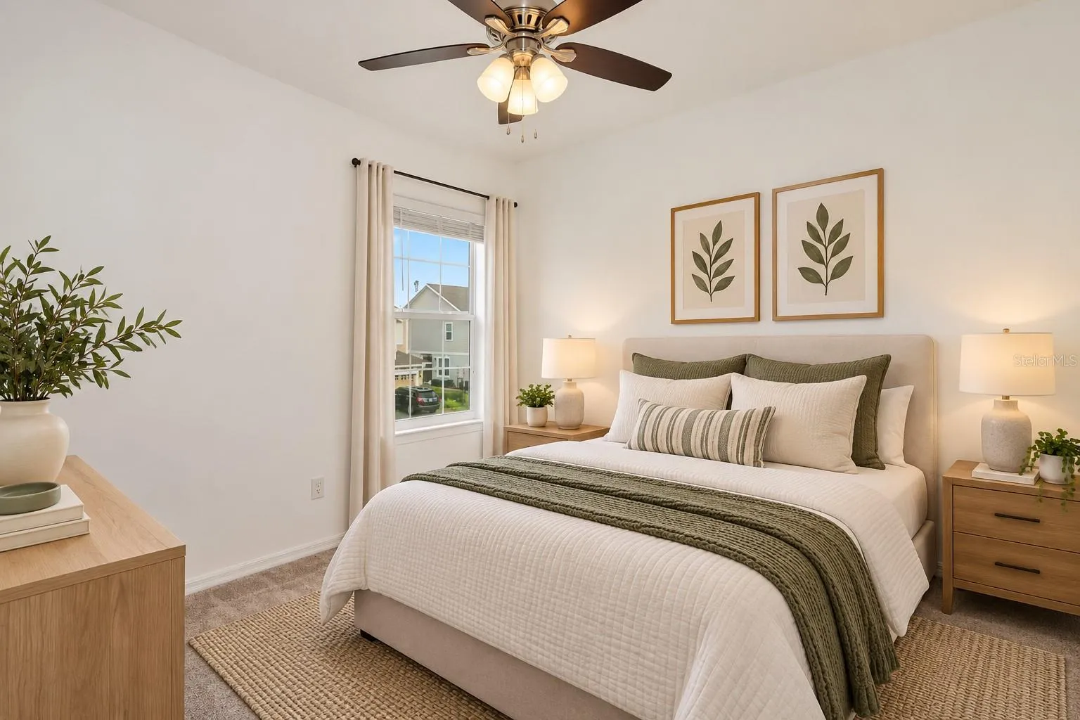 Comfortable 3rd bedroom with ceiling fan, neutral carpeting and natural light.