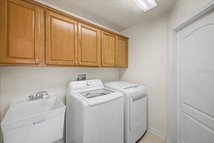 Laundry Room with Washer, Dryer, Utility Sink & Cabinets
