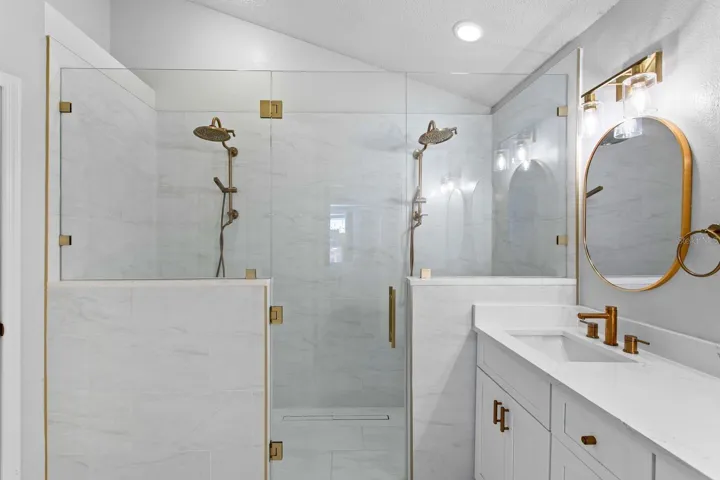 Custom walk-in shower with dual rainheads and digital controls